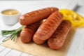 Delicious grilled sausages on white wooden , closeup. Barbecue food Royalty Free Stock Photo