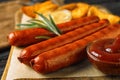Delicious grilled sausages on  board, closeup. Barbecue food Royalty Free Stock Photo