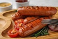 Delicious grilled sausages on  tray, closeup. Barbecue food Royalty Free Stock Photo