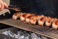 Delicious grilled sousages. Barbiquing sousages on hot grill