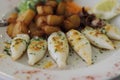 Delicious grilled squids with potatoes and lemon and littlle oct