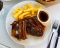 Grilled veal ribs with french fries and herbal sauce Royalty Free Stock Photo