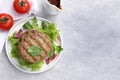 Delicious grilled vegan cutlets, lettuce, spinach and tomatoes on light grey table, flat lay. Space for text Royalty Free Stock Photo