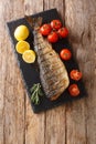 Delicious grilled whole humpback salmon diet on a slate board. Vertical top view