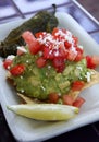 Delicious Guacamole Appetizer with Lime Slice and Pepper