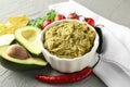 Delicious guacamole with vegetables on textured background Royalty Free Stock Photo