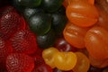 Delicious gummy fruit shaped candies as background, closeup