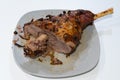 Delicious cooked leg of lamb isolated on plate