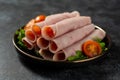 Delicious ham slices in a plate, over dark background Royalty Free Stock Photo