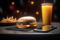 Delicious hamburger over a smart phone .Fast food delivery app concept.