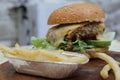 Delicious hamburgers and potato chips accompanied by warm tomato sauce.