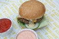 Delicious hamburgers and potato chips accompanied by warm tomato sauce.