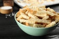 Delicious hard chucks on black wooden table, closeup