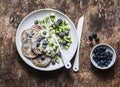 Delicious healthy breakfast - whole wheat pancakes with greek yogurt, blueberries, kiwi, honey and nuts on a wooden background, to Royalty Free Stock Photo