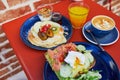 Delicious healthy brunch with avocado and salmon toast, boiled egg, pancakes with fruits and maple syrup