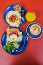 Delicious healthy brunch with avocado and salmon toast, boiled egg, pancakes with fruits and maple syrup