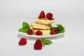 Delicious and healthy cottage cheese pancakes on a white saucer, poured with BlackBerry jam Royalty Free Stock Photo