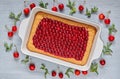 Delicious healthy dessert - cherry pie in the baking dish on the gray kitchen table. Cold summer tart decorated with cherry jelly Royalty Free Stock Photo