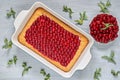 Delicious healthy dessert - cherry pie with jam in the baking dish on the gray kitchen background. Homemade cold cheesecake Royalty Free Stock Photo