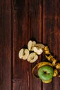 Delicious and healthy food for healthy and active people. One whole green Apple and a red Apple cut into pieces lie on the wooden Royalty Free Stock Photo