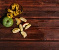 Delicious and healthy food for healthy and active people. One whole green Apple and a red Apple cut into pieces lie on the wooden Royalty Free Stock Photo