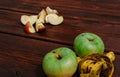 Delicious and healthy food for healthy and active people. Two whole green apples and one red Apple cut into pieces are lying on Royalty Free Stock Photo