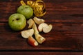 Delicious and healthy food for healthy and active people. Two whole green apples and one red Apple cut into pieces are lying on Royalty Free Stock Photo