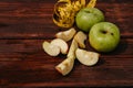 Delicious and healthy food for healthy and active people. Two whole green apples and one red Apple cut into pieces are lying on Royalty Free Stock Photo