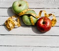 Delicious and healthy food is on the kitchen table. Three apples-yellow, green and red on a white wooden background and a yellow Royalty Free Stock Photo