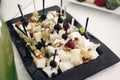 Delicious, healthy greek salad with goat cheese, olives and grapes at wedding reception, tasty cheese snack close-up, restaurant Royalty Free Stock Photo