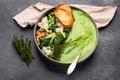 Delicious healthy green cream soup in a bowl with croutons on table Royalty Free Stock Photo