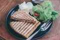 Delicious Healthy Grill sandwich ham cheese and salad  lettuce, ham, cheese, tomato and potato chipwith a cup of coffee. Royalty Free Stock Photo