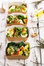 Delicious and healthy lunch with salmon fish fillet in a card box. Salad with smoked salmon, cheese, eggs, onion and vegetables Royalty Free Stock Photo