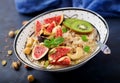 Delicious and healthy oatmeal with figs, nuts, kiwi and seeds.
