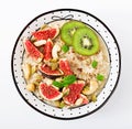 Delicious and healthy oatmeal with figs, nuts, kiwi and seeds