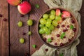 Delicious and healthy oatmeal with grapes, nuts and apples. Royalty Free Stock Photo