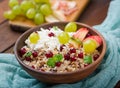 Delicious and healthy oatmeal with grapes, nuts, apples and cottage cheese. Royalty Free Stock Photo