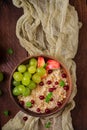 Delicious and healthy oatmeal with grapes, nuts and apples. Royalty Free Stock Photo