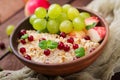 Delicious and healthy oatmeal with grapes, nuts and apples. Royalty Free Stock Photo