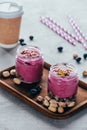 delicious healthy pink smoothie with granola nuts