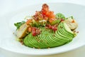 A delicious and healthy salad with artichokes, avocado, tuna and quinoa, served in a white plate on a white tablecloth. Restaurant Royalty Free Stock Photo