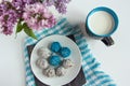 Delicious dried fruit truffle candies with coconut, sprinkled with powdered sugar, on a white saucer, white background Royalty Free Stock Photo