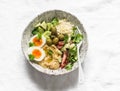 Delicious healthy vegetarian breakfast, brunch, lunch - couscous, boiled egg, avocado, fresh vegetables, hummus in one bowl on a Royalty Free Stock Photo