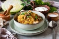 Delicious and hearty family lunch: cabbage stewed with vegetables, fresh herbs and mushrooms in a beautiful plate with a Royalty Free Stock Photo