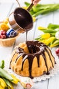 Delicious holiday slovak and czech cake babovka with chocolate glaze. Pouring chocolate topping. Easter decorations - spring Royalty Free Stock Photo