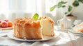 Delicious home baked Angel food cake garnished with fresh mint on white plate. Classic American cuisine pastry