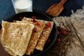 Delicious home-cooked food. Pancakes in a frying pan with cranberry berries and milk. Rustic style Royalty Free Stock Photo