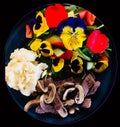 Delicious home cooked potato beef and fresh garden salad with flower petals and natures greens