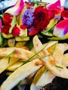 Delicious home cooked potato fries fresh garden salad with flower petals and natures greens