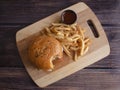 Homemade Bacon Cheese Burger with Onion Rings and Spicy French Fries Royalty Free Stock Photo